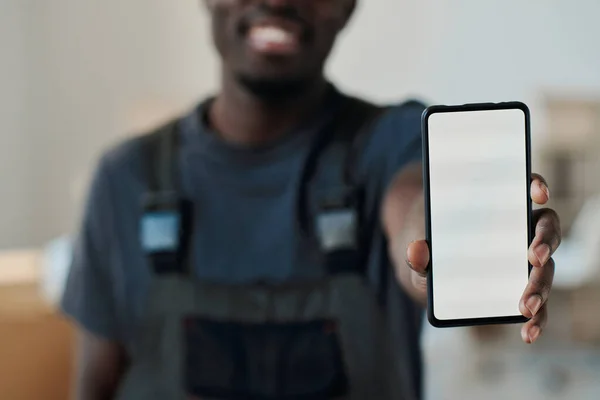 stock image Close-up of African American man showing the empty screen of smartphone to the camera