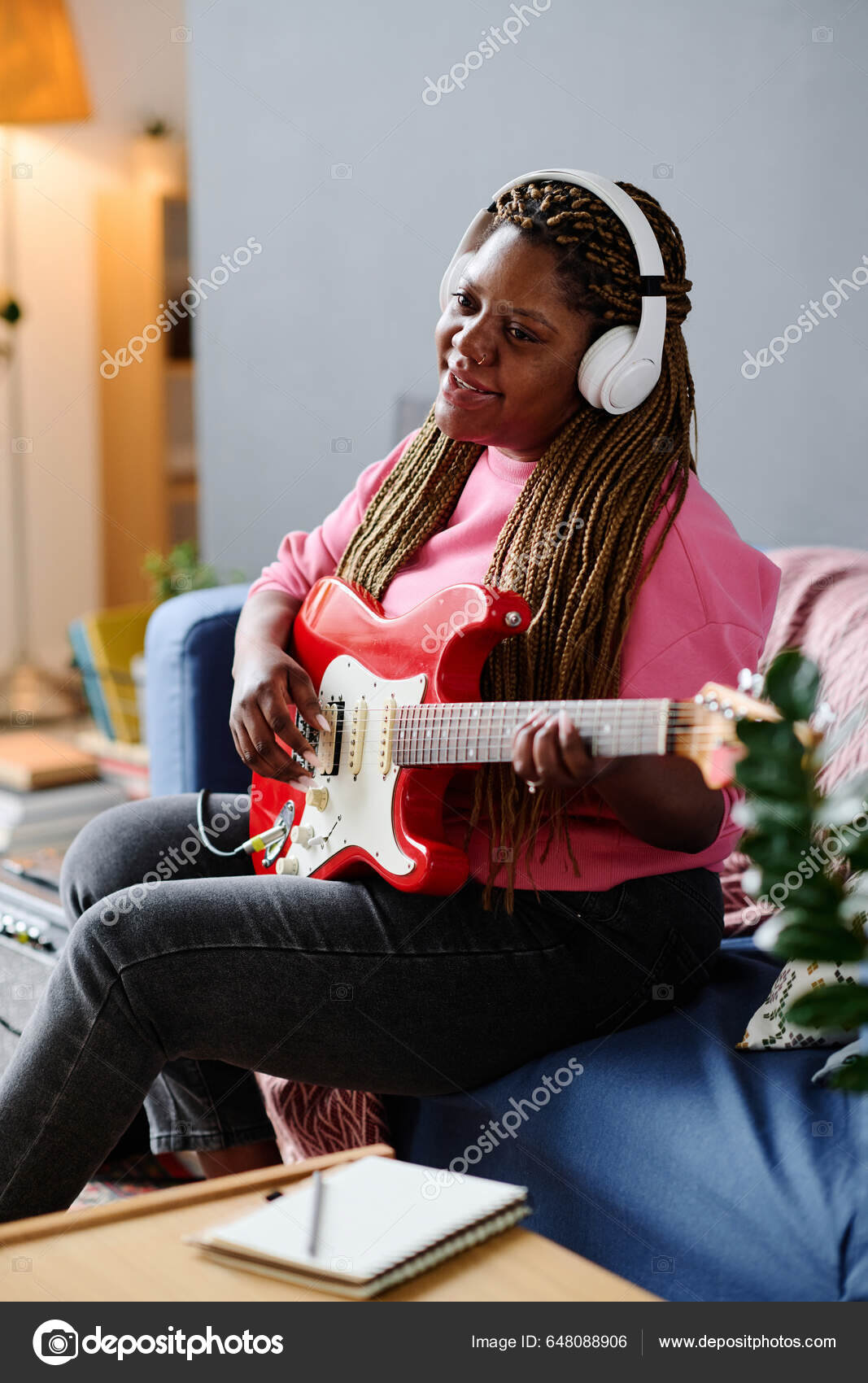 African American Girl Wireless Headphones Playing Guitar Singing