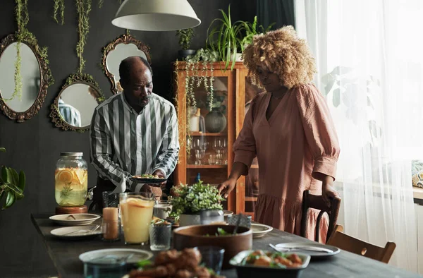 stock image African family setting the table for holiday dinner together in dining room