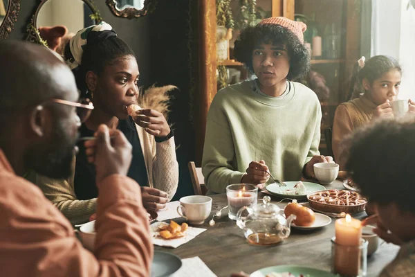 stock image Big African family sitting at table together drinking tea and eating pie