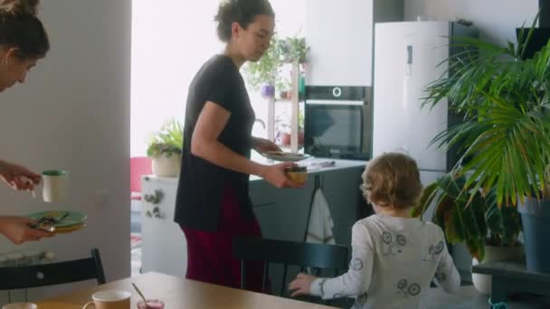 Little Boy Helping Lesbian Parents Bring Dishes Sink While Clearing — Stock Video