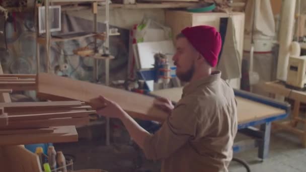 Blanke Mannelijke Houtbewerker Neemt Plank Van Plank Tijdens Het Werken — Stockvideo