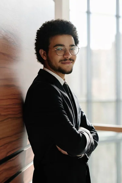 Portrét Mladého Podnikatele Brýlích Černém Obleku Úsměvem Kameru Která Opírá — Stock fotografie