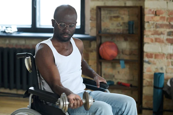 Африканский Мужчина Инвалидной Коляске Делает Реабилитационные Упражнения Гантелями Дома — стоковое фото