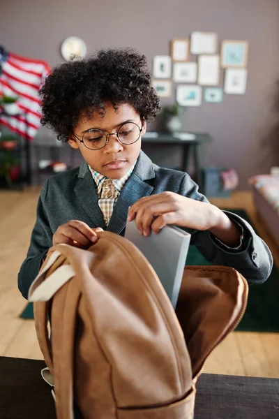 African American Schoolboy Eyeglasses Packing Books His Backpack Table Room — Stock Photo, Image