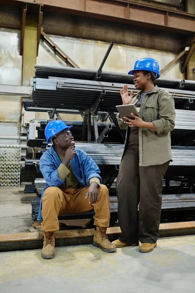 태블릿 사용하고 작업장에서 동료와 일하는 시간에 이야기하는 아프리카 노동자 — 스톡 사진