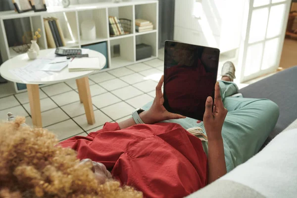 소파에서 휴식을 취하는 아프리카 소녀와 디지탈 태블릿을 사용하여 온라인으로 영화를 — 스톡 사진