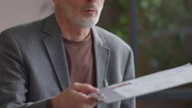 Üst düzey Kafkasyalı işadamının iş görüşmesi sırasında CV 'yi kadın İK yöneticisine verirken aşağı eğilmesini.