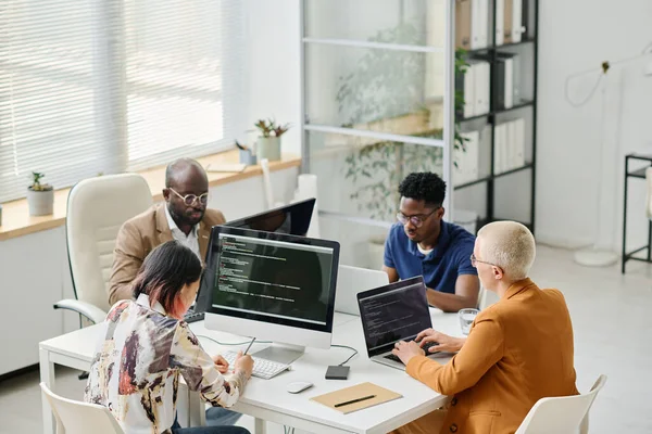 stock image High angle view of Group of programmers working on computer and laptop with codes during teamwork at office