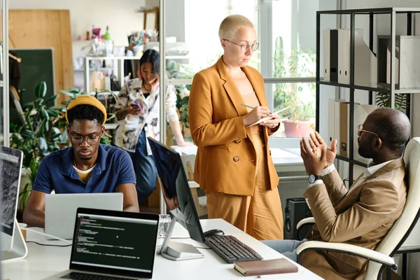 stock image Business people discussing new project and making notes during teamwork at table at office