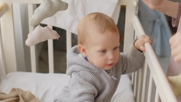 Adorable Baby Boy Playing Crib Toys While Mother Standing Bed — Stock Video