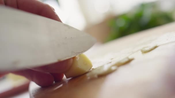 用小刀把大蒜头切割成薄片的男性厨师双手合十角截图 — 图库视频影像