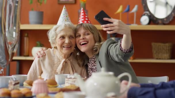 Happy Young Woman Party Hat Embracing Joyous Grandmother Smiling Posing — Stock Video