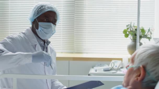Inyección Enfoque Rack Del Médico Afroamericano Máscara Protectora Sombrero Guantes — Vídeo de stock