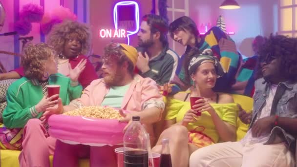 Zoom Shot Brightly Dressed Multiethnic Friends Having Drinks Snacks Sitting — Stock Video