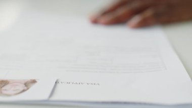 Vize memurunun başvuru formuna onaylı damgayı basarken yakın plan çekimleri