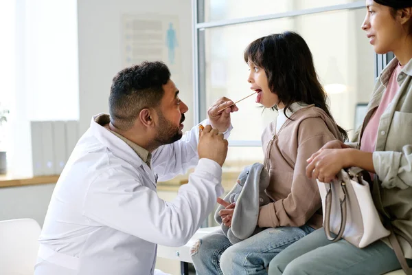 Pediatra Examinando Garganta Del Niño Mientras Visitan Hospital Con Madre — Foto de Stock