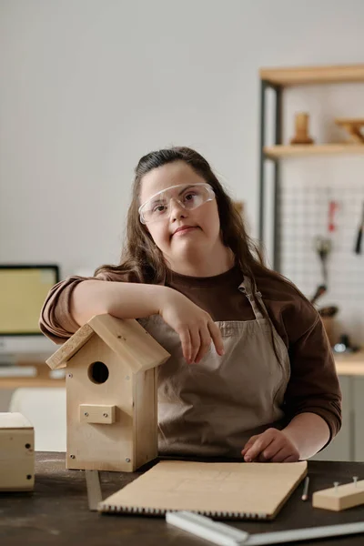 上下症候群の女の子の垂直肖像画カメラを見ながら家を作るための鳥のためのワークショップ — ストック写真