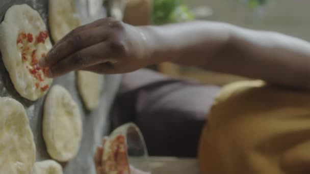 Vertical Close Shot Hands Unrecognizable Woman Sprinkling Topping Flattened Dough — Stock Video
