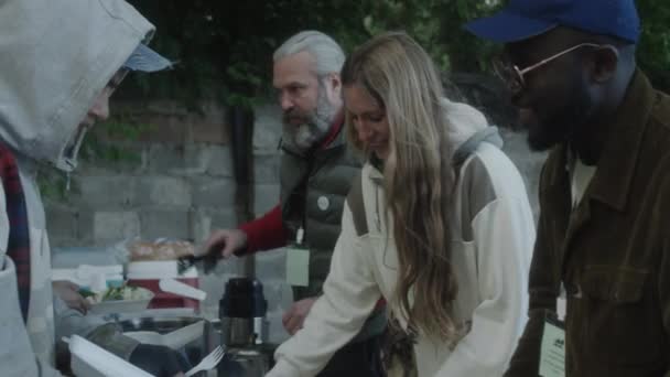 Multiethnic Volunteers Giving Free Food Homeless People Outdoor Soup Kitchen — Stock Video
