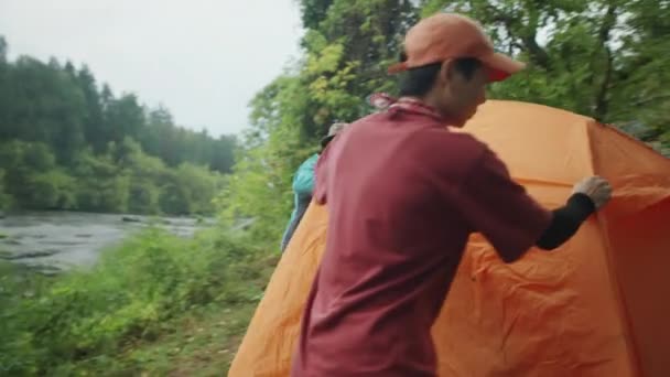 两名亚洲女性游客在远足时在河边搭帐篷 — 图库视频影像