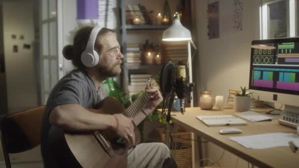 Medium Arc Shot Male Musician Headphones Playing Guitar Singing Mic — Stock Video