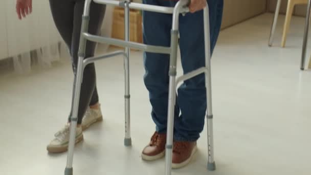 Tilt Shot Cheerful Female Caregiver Assisting Elderly Man Using Walker — Vídeos de Stock