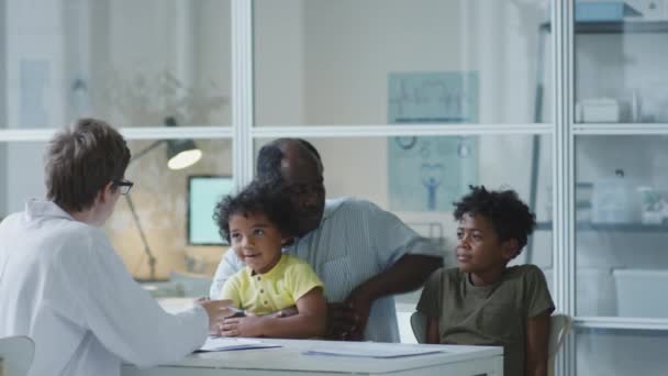 African American Father Sitting Two Kids Medical Office Having Discussion — 비디오