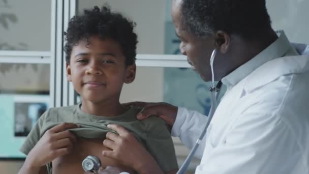 Pediatra Afro Americano Usando Estetoscópio Enquanto Examina Menino Durante Check — Vídeo de Stock