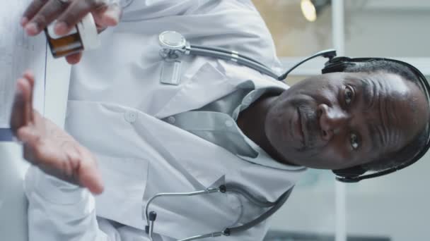 Vertical Shot African American Doctor White Coat Headset Talking Camera — Vídeos de Stock