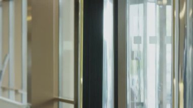 Caucasian businessman walking in hotel, greeting black manager with handshake and going with him through lobby