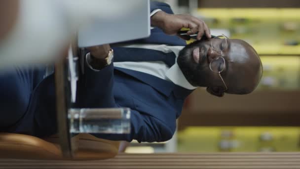 Vertical Shot African American Businessman Using Laptop Speaking Mobile Phone — Vídeos de Stock