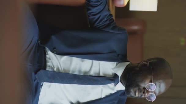 Vertical Portrait Confident African American Businessman Formal Suit Glasses Sitting — Video