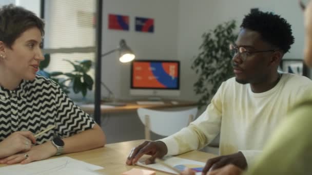 アフリカ系アメリカ人男性 オフィスのクリエイティブチームミーティング中に多民族の同僚とアイデアを議論 — ストック動画