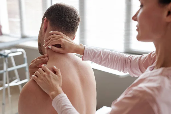 Vrouwelijke Massage Therapeut Onderzoeken Nek Van Patiënt Tijdens Medische Procedure — Stockfoto
