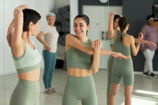 stock image Group of elderly people exercising with fitness instructor in health club