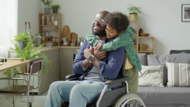 Μέτριο Πλάνο Του Μικρού Αγοριού Αγκαλιάζει Ευτυχισμένη Αφροαμερικανός Μπαμπάς Αναπηρική — Αρχείο Βίντεο