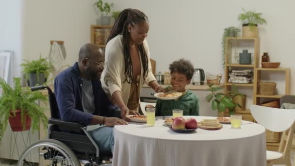 Medium Long Shot African American Man Wheelchair Sitting Kitchen Table — Vídeo de Stock