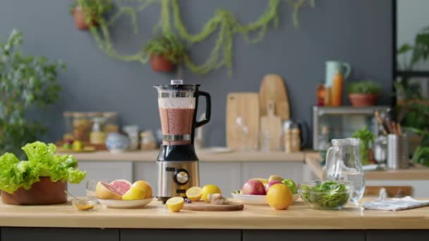 キッチンテーブルにスムージーと新鮮な果物 ブレンダーのメディア選択的なフォーカスショット — ストック動画