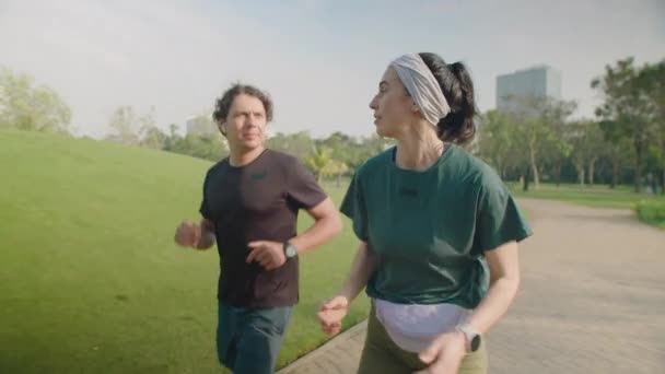 Medium Long Slow Motion Shot Young Couple Sportswear Running Park — Stock Video