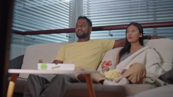 Diverse Family Couple Sitting Together Sofa Dark Living Room Eating — Stock Video