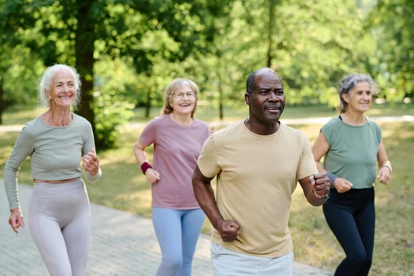 Multiethnic group of senior people jogging together in the park