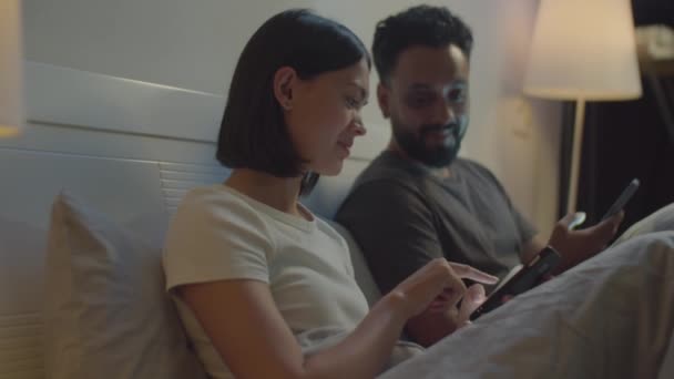 Young Family Couple Sitting Bed Night Discussing Social Media Smartphone — Stock Video