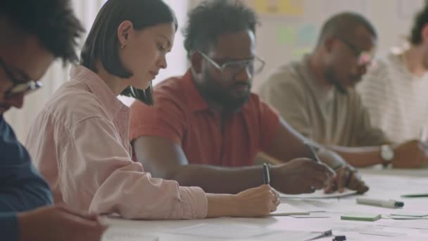 Rack Focus Shot Group Diverse Migrant Students Writing Desk Exam — Stock Video