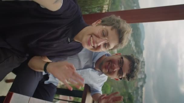 年轻而快乐的夫妻坐在山景咖啡馆里 通过在线视频通话 一边挥手一边在镜头前聊天的垂直Pov照片 — 图库视频影像