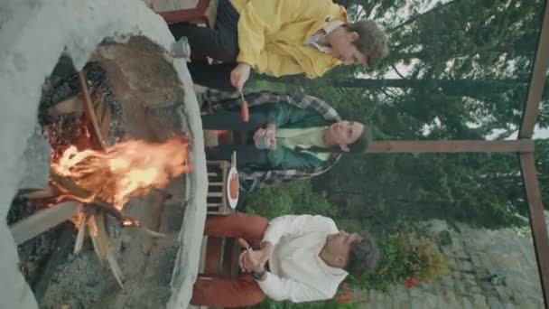 Vertical Shot Company Young Friends Sitting Campfire Having Grilled Sausages — Stock Video