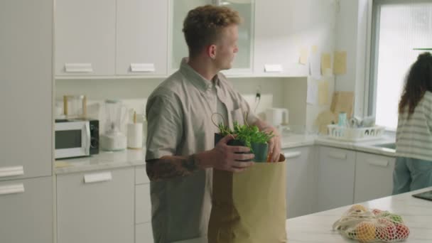 Young Man Bringing Groceries Taking Them Shopping Bag Chatting His — Stock Video