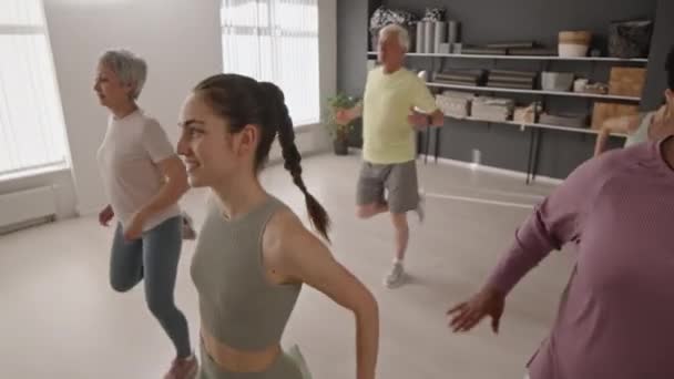 Group Senior People Sportswear Doing Butt Kick Exercise Young Female — Stok video