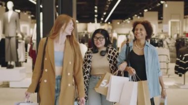 Üç güzel çok ırklı kız arkadaşın sohbetinin orta yavaşlığı. Bir yandan şık giyim mağazasından ellerinde kağıt poşetlerle, bir yandan da hafta sonları alışveriş merkezinde alışveriş yaparken.