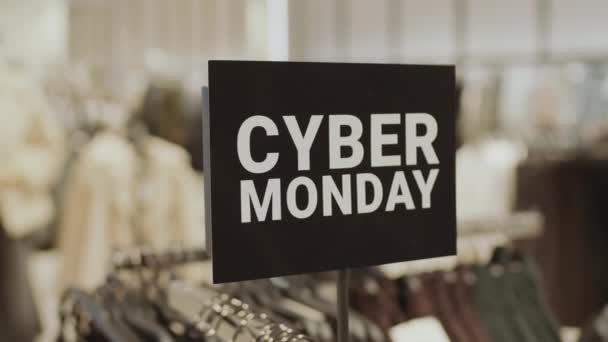 People Closeup Black Cyber Monday Sign Card Rack Clothes Store — Stock video